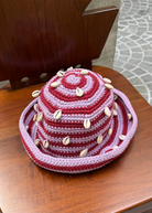 KABE SHOP INC handmade crochet bucket hat in pink and maroon stripes, decorated with natural white sea shells.
