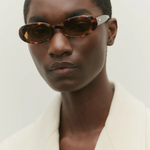 KABE SHOP INC Valentina oval sunglasses in tortoiseshell Italian acetate worn by a model in a white blazer