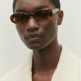 KABE SHOP INC Valentina oval sunglasses in tortoiseshell Italian acetate worn by a model in a white blazer