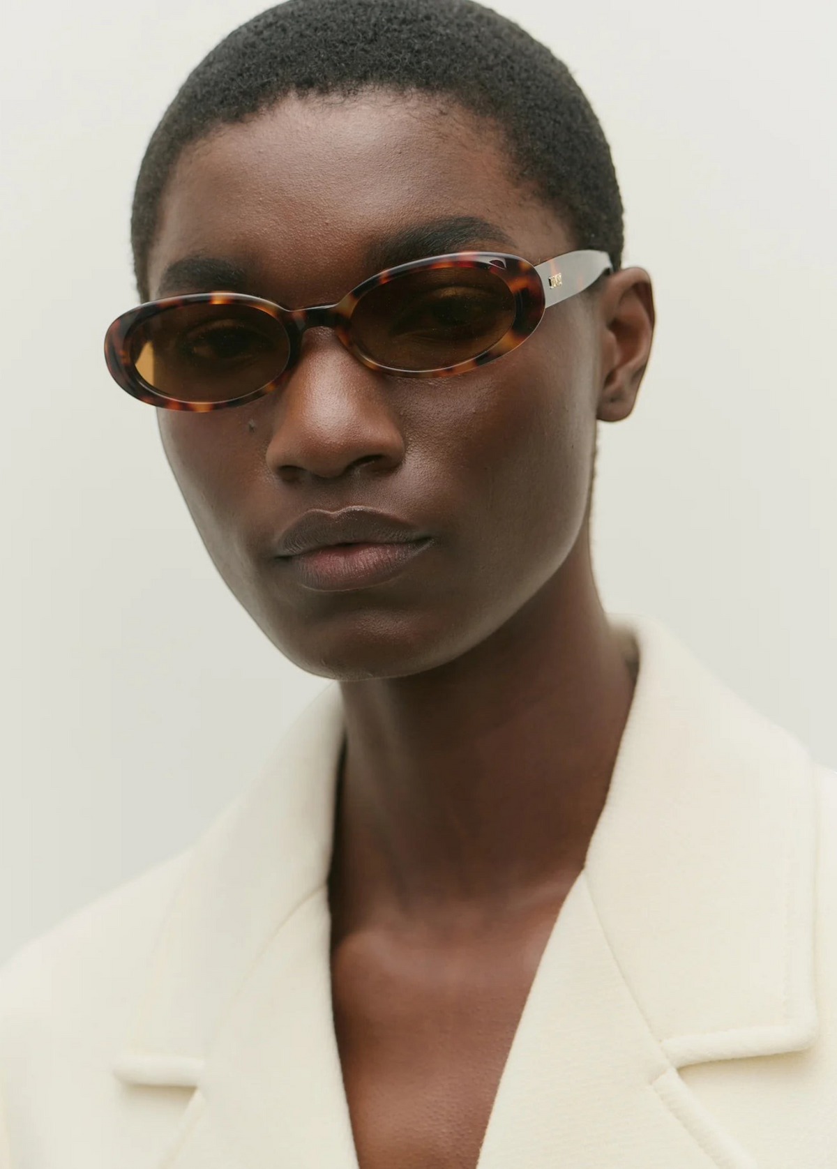 KABE SHOP INC Valentina oval sunglasses in tortoiseshell Italian acetate worn by a model in a white blazer