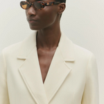 KABE SHOP INC Valentina oval sunglasses in tortoiseshell acetate worn by a model in a cream blazer