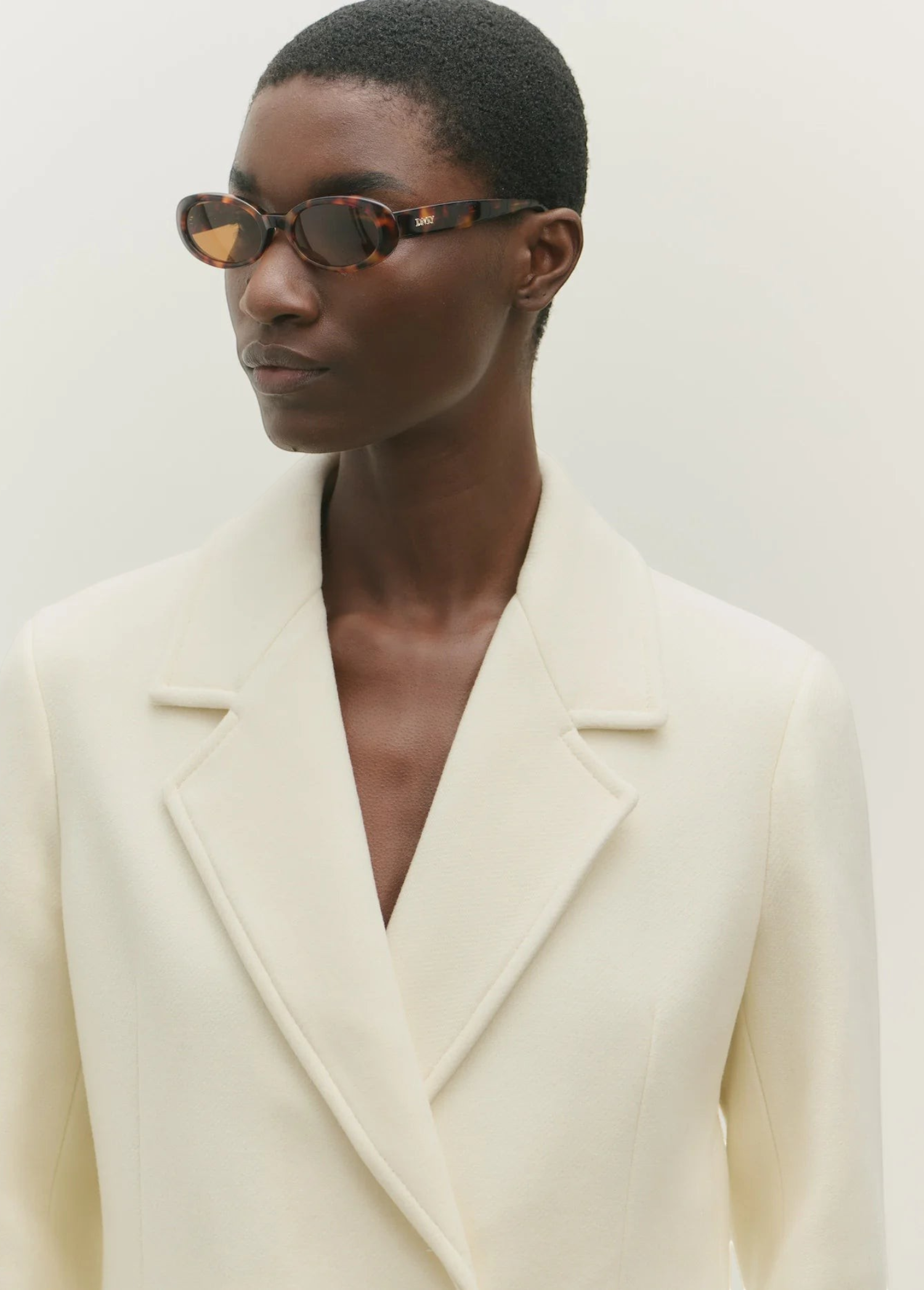 KABE SHOP INC Valentina oval sunglasses in tortoiseshell acetate worn by a model in a cream blazer