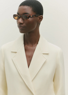 KABE SHOP INC Valentina oval sunglasses in tortoiseshell acetate worn by a model in a cream blazer