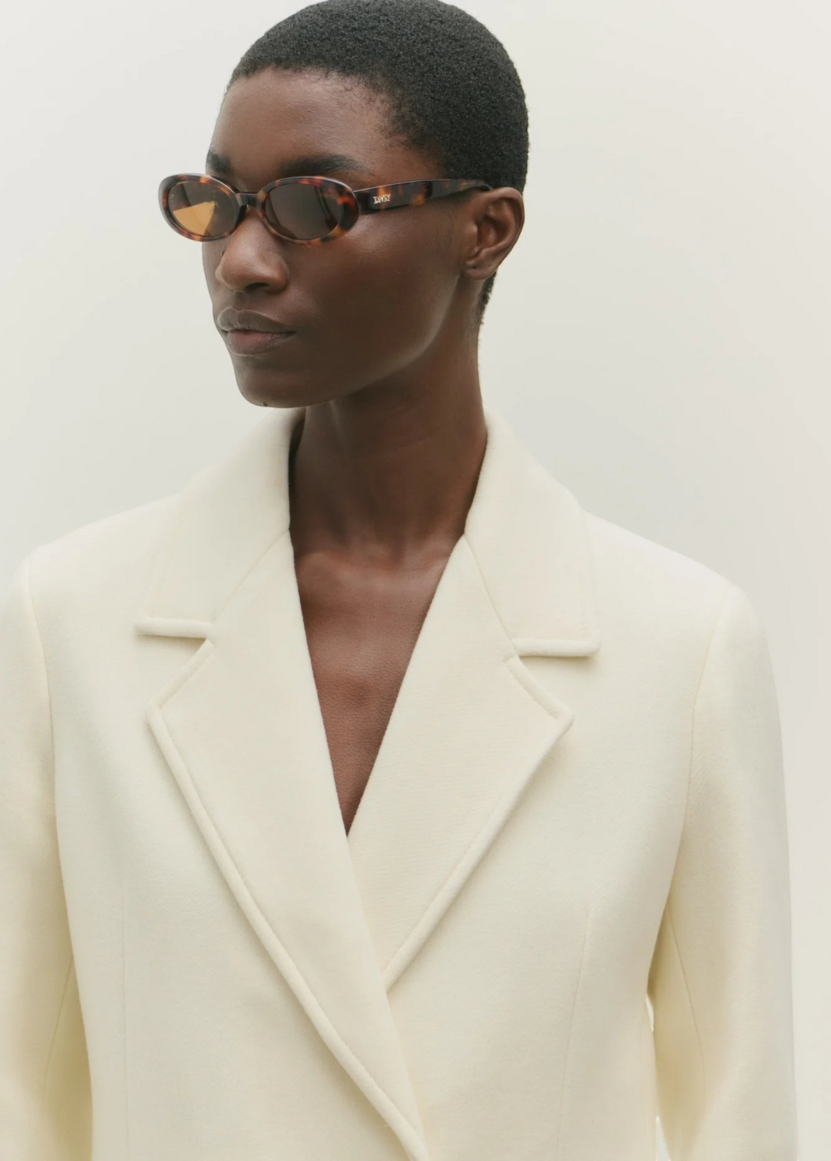 KABE SHOP INC Valentina oval sunglasses in tortoiseshell acetate worn by a model in a cream blazer
