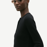 KABE SHOP INC Valentina oval sunglasses in translucent beige acetate worn by a model in a black sweater