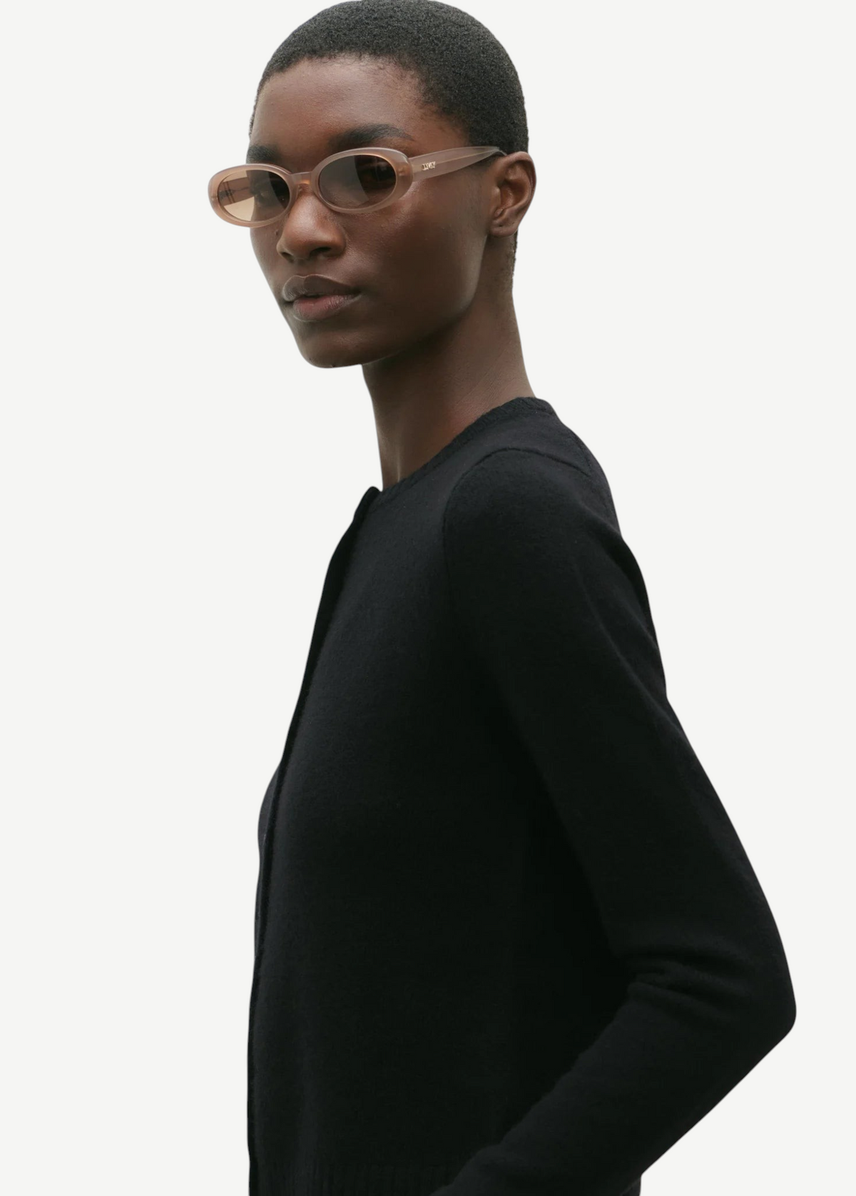 KABE SHOP INC Valentina oval sunglasses in translucent beige acetate worn by a model in a black sweater
