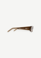 A side view of brown, semi-transparent rectangular sunglasses named Billy, featuring thick frames and the DKNY logo on the temple, set against a plain white background.