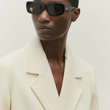 Model wearing KABE SHOP INC Vivian black rectangular acetate sunglasses with a cream wool blazer