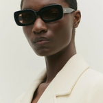 KABE SHOP INC Vivian statement sunglasses with a bold black rectangular acetate frame worn by a model.