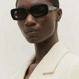 KABE SHOP INC Vivian statement sunglasses with a bold black rectangular acetate frame worn by a model.