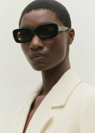 KABE SHOP INC Vivian statement sunglasses with a bold black rectangular acetate frame worn by a model.