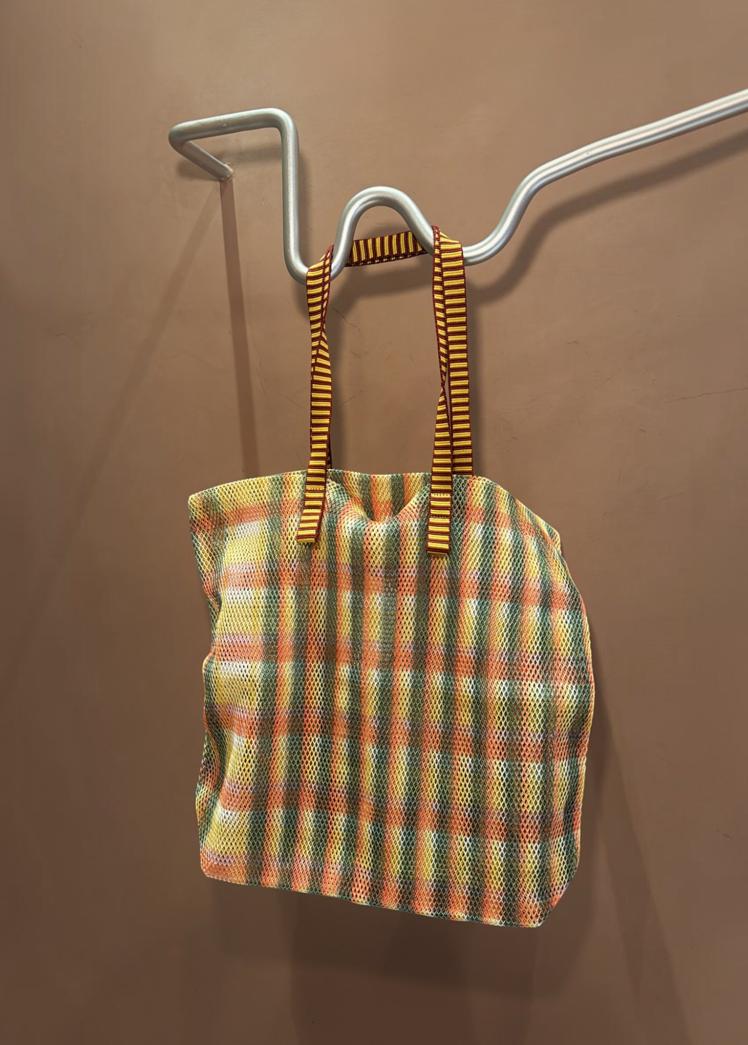 KABE SHOP INC Kanpur bag featuring a vibrant multi-colored mesh plaid pattern with striped fabric handles.