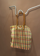 KABE SHOP INC Kanpur bag featuring a vibrant multi-colored mesh plaid pattern with striped fabric handles.