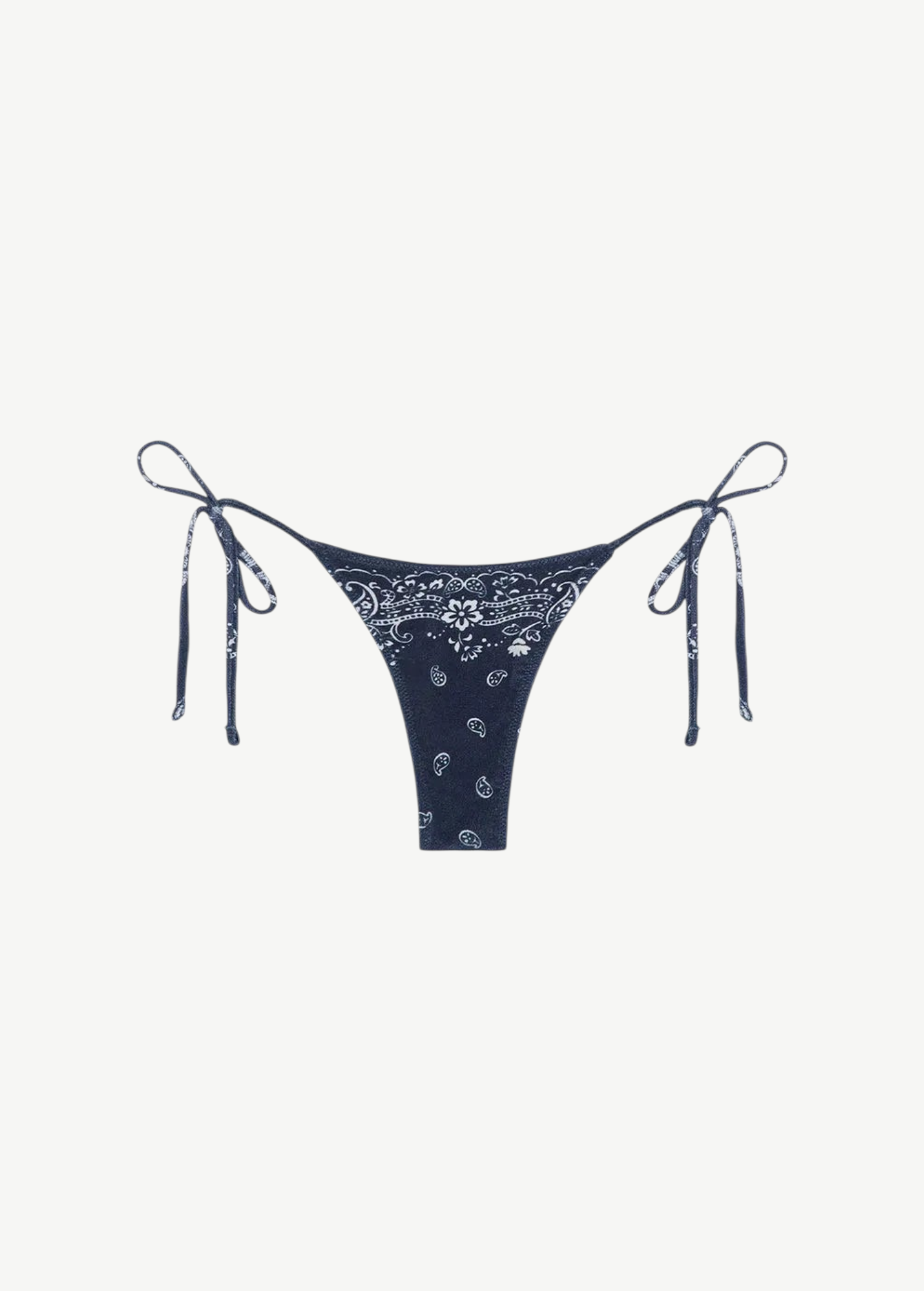 Praia Bottom in navy blue with a white paisley bandana print, crafted from eco-terry fabric, features a low-rise silhouette and adjustable side ties, shown on a white background.