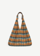 KABE SHOP INC Udaipur bag featuring a vibrant orange and teal plaid mesh design with striped woven shoulder straps.