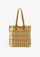 KABE SHOP INC Kanpur bag featuring a vibrant yellow and orange plaid mesh design with striped shoulder straps.