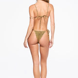 A woman stands with her back to the camera against a white background, wearing the Equator Top—a leopard print recycled nylon triangle bikini top—and black sandals. Her hair is loose and wavy.