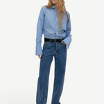 Model wearing KABE SHOP INC Everyday Jeans in medium blue denim with a relaxed straight-leg fit and black belt