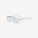 Evangeline eyeglasses featuring a sleek stainless steel silver frame, thin rectangular blue-tinted lenses with UV protection, and clear, slightly curved earpieces, displayed on a white background.
