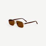 The Evangeline sunglasses feature brown lenses, thin gold stainless steel frames, and dark arms, offering reliable UV protection—all shown against a white background.