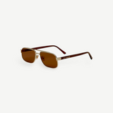 The Evangeline sunglasses feature brown lenses, thin gold stainless steel frames, and dark arms, offering reliable UV protection—all shown against a white background.