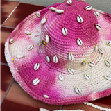 KABE SHOP INC Wika crochet hat in pink and white tie-dye featuring decorative cowrie shells and a chin strap