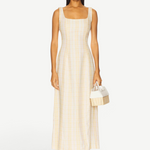 Model wearing a KABE SHOP INC Lenice midi dress in yellow plaid linen with a square neckline and fitted silhouette