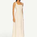 Model wearing a KABE SHOP INC Lenice midi dress in cream and yellow plaid linen with a square neckline
