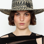 KABE SHOP INC rhomboidal pattern straw fedora hat worn by a woman with short brown hair against a white background