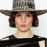 KABE SHOP INC rhomboidal pattern straw fedora hat worn by a woman with short brown hair against a white background