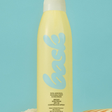 KABE SHOP INC non-aerosol SPF 30 sunscreen spray in a yellow bottle on sand with a seashell against a blue background