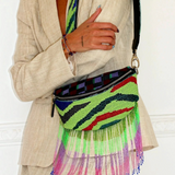 KABE SHOP INC Nayade bag featuring vibrant green, red, and black beadwork with long, colorful beaded fringe tassels.