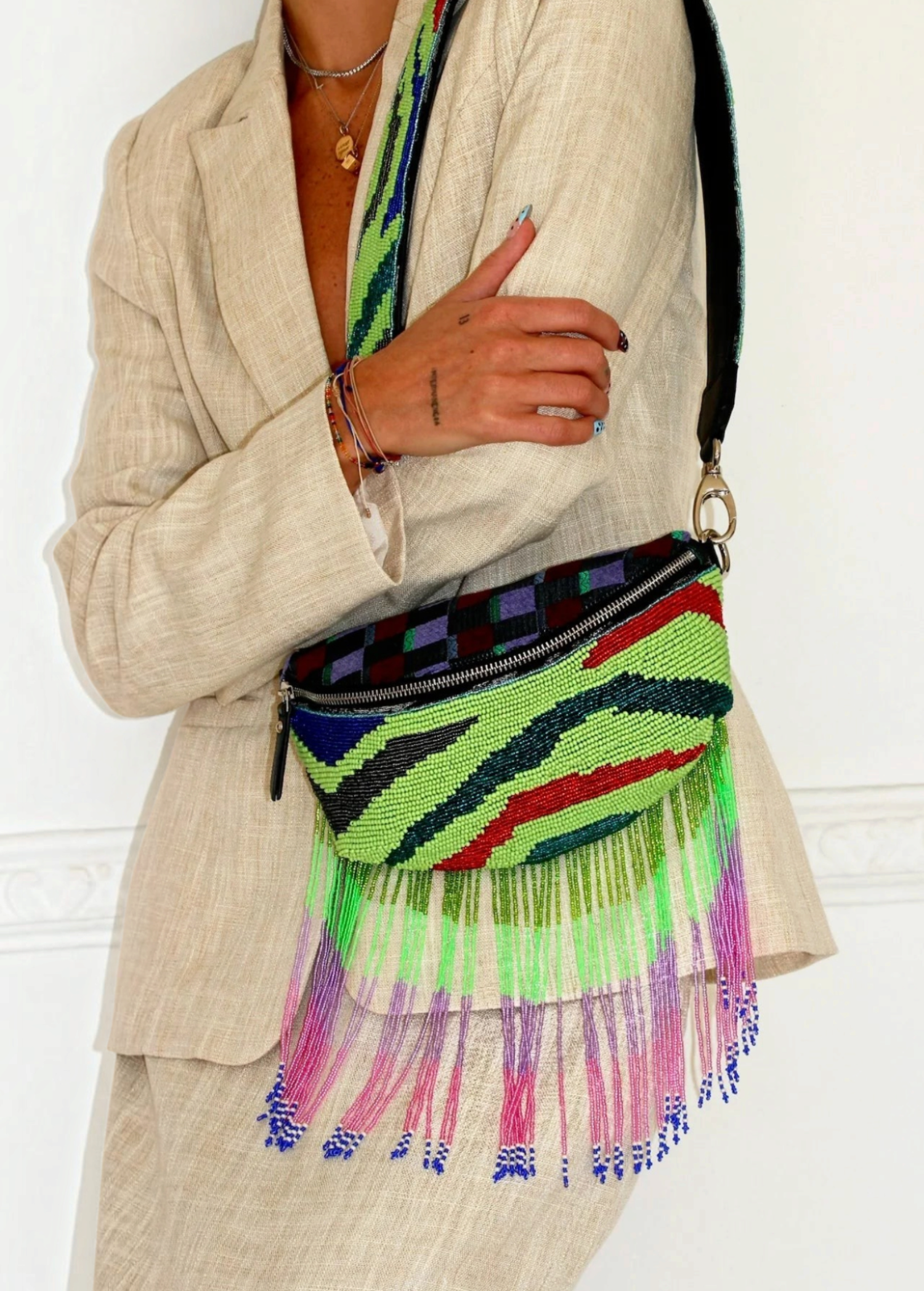 KABE SHOP INC Nayade bag featuring vibrant green, red, and black beadwork with long, colorful beaded fringe tassels.
