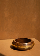 KABE SHOP INC set of three sculptural wood and resin bangles featuring a natural wood grain and gold resin detail.