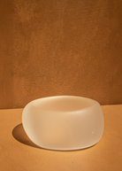 KABE SHOP INC sculptural beige resin bangle with a smooth, rounded minimalist design