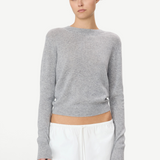 Model wearing a grey KABE SHOP INC Francis cashmere sweater with a slim fit and cropped hem on a white background