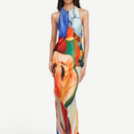Model wearing KABE SHOP INC Salpicon long silk dress with vibrant multicolor fruit print and fluid halter neckline