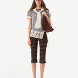 KABE SHOP INC Gianna pants featuring a brown polka dot pattern, flared silhouette, and white crochet waist detail.