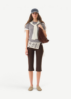 KABE SHOP INC Gianna pants featuring a brown polka dot pattern, flared silhouette, and white crochet waist detail.