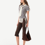 KABE SHOP INC Gianna pants in brown with white polka dots, featuring a crochet waist detail and flared silhouette.