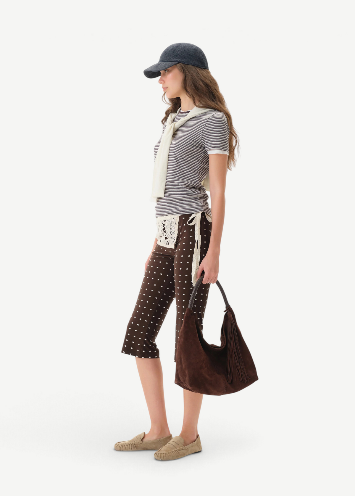 Model wearing KABE SHOP INC Gianna Pants featuring a brown polka dot print, flared silhouette, and crochet detail.