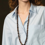 KABE SHOP INC Lark Drip Necklace featuring faceted smoky quartz beads and a gold claw pendant with peridot drops.