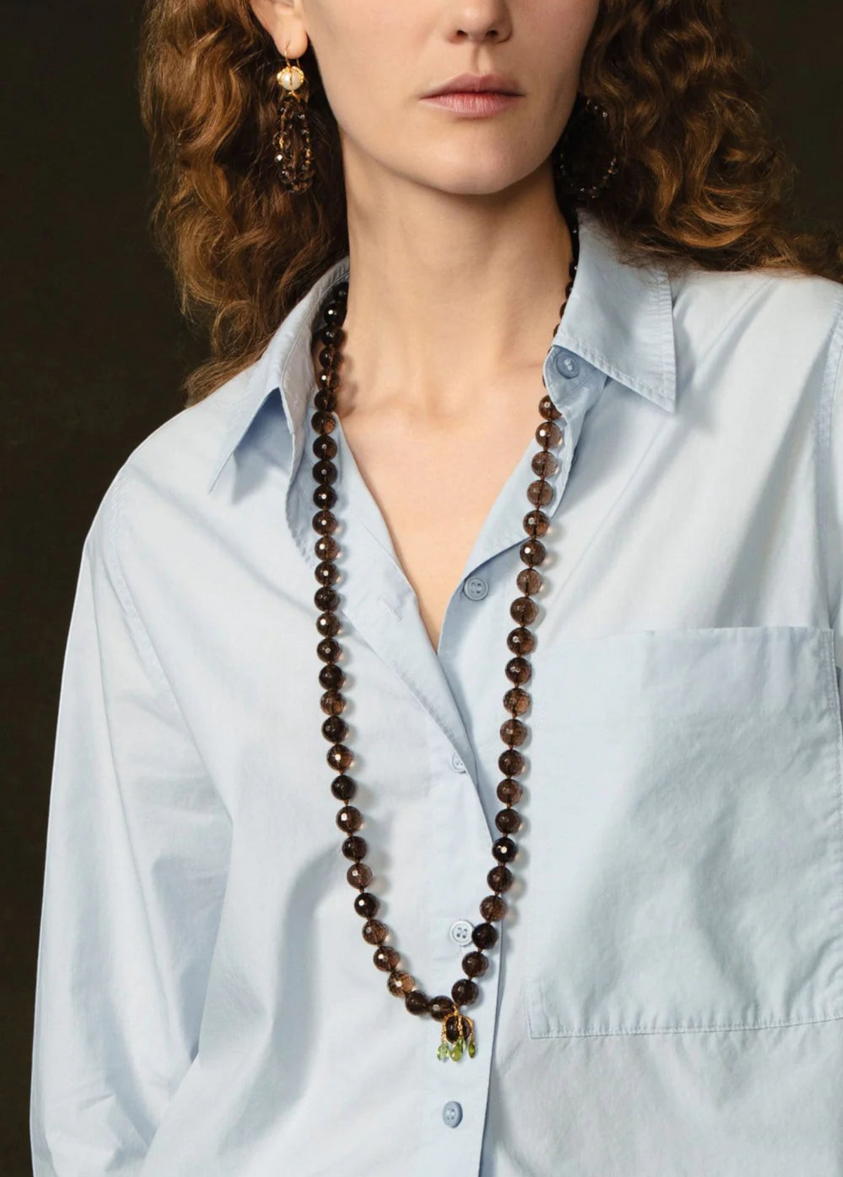 KABE SHOP INC Lark Drip Necklace featuring faceted smoky quartz beads and a gold claw pendant with peridot drops.