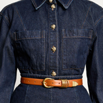 KABE SHOP INC Hollyhock belt in tan Italian calfskin leather with 24K gold hardware worn over a dark denim dress