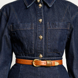 KABE SHOP INC Hollyhock belt in tan Italian calfskin leather with 24K gold hardware worn over a dark denim dress