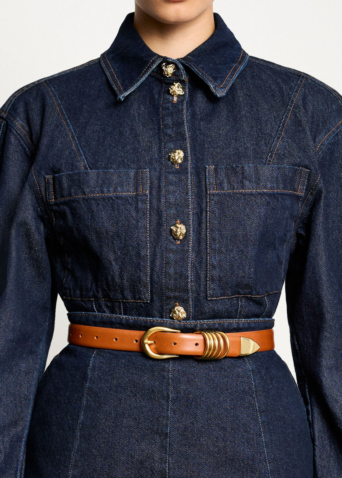 KABE SHOP INC Hollyhock belt in tan Italian calfskin leather with 24K gold hardware worn over a dark denim dress