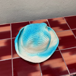 KABE SHOP INC Pora crochet hat featuring a blue and white tie-dye pattern on a textured handmade surface.