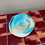 KABE SHOP INC Pora crochet hat featuring a blue and white tie-dye pattern on a textured handmade surface.