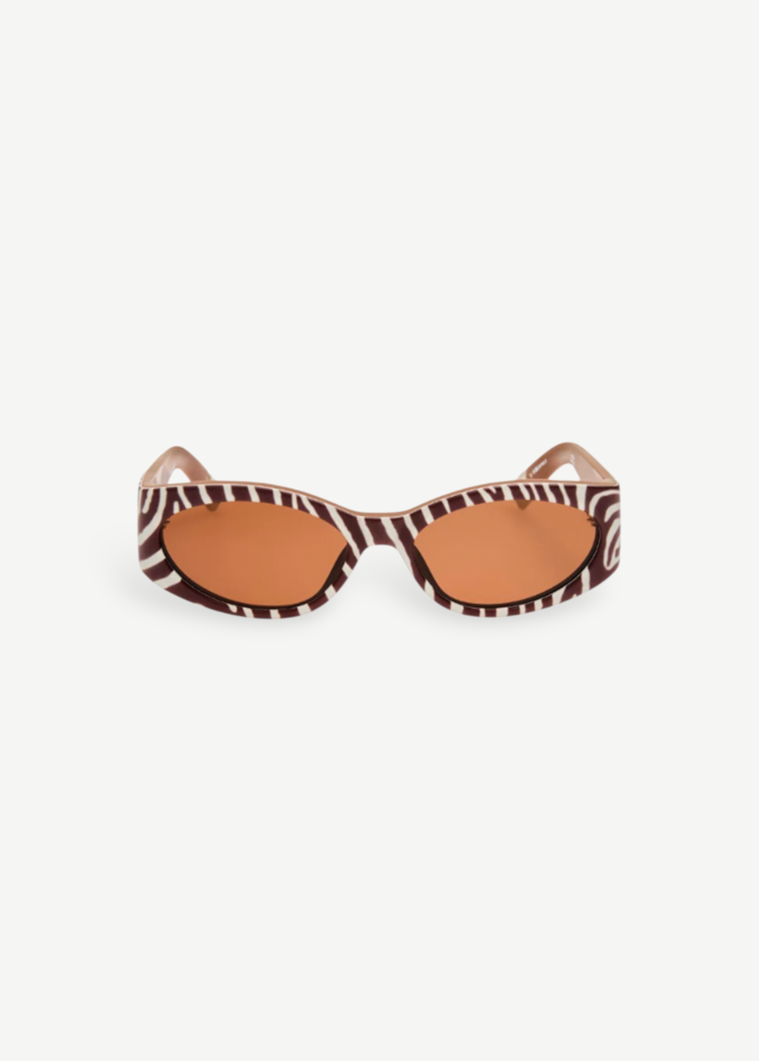 KABE SHOP INC Ovalo sunglasses featuring a bold zebra print oval frame and warm amber tinted lenses.