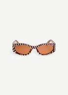 KABE SHOP INC Ovalo sunglasses featuring a bold zebra print oval frame and warm amber tinted lenses.